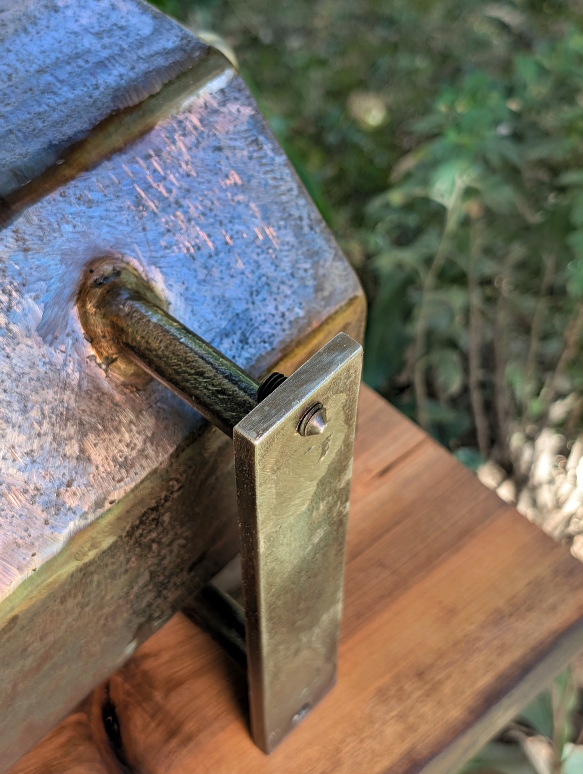 Close-up of the adjustable foot bracket bolted to a leg