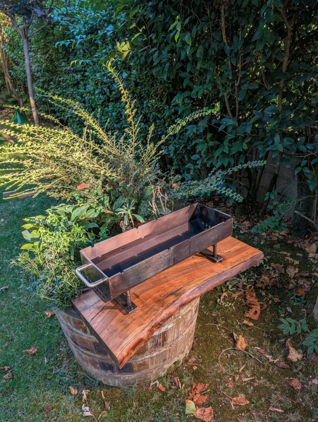 The firebox test-fitted on the walnut slab before the legs and grate