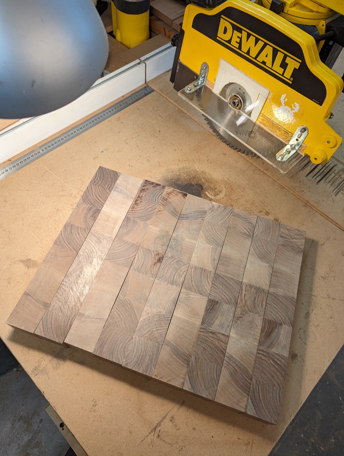 End-grain strips dry-laid into a checkerboard pattern on the bench