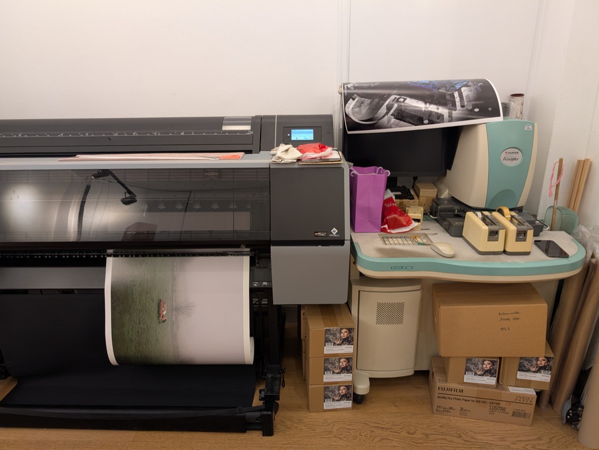 A large format printer feeding out the fine art print at 645Lab